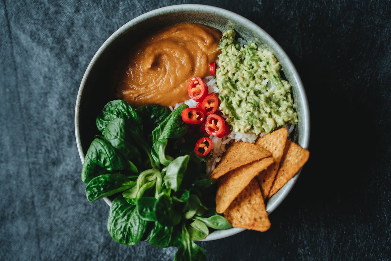 Delicious vegan bowl featuring avocado, rice, and fresh greens perfect for a healthy meal.